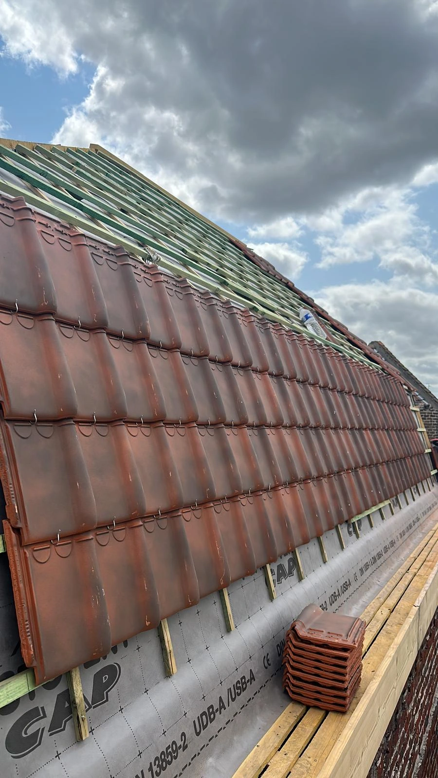 Travaux de rénovation de toiture avec tuiles en cours de pose — Full Renov’Habitat